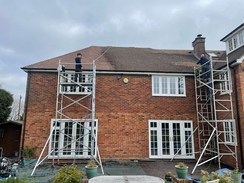Roof cleaning carried out safely from scaffold towers by The Roof Moss Cleaners in Ashtead